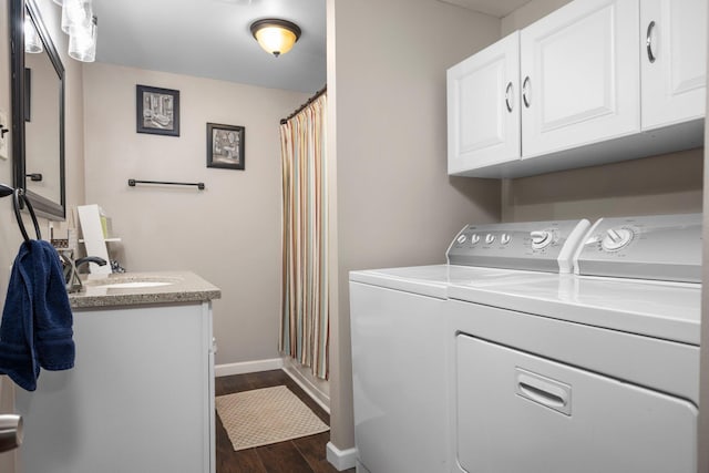 laundry area with cabinets, sink, dark wood-type flooring, and independent washer and dryer