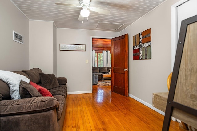 living room with ceiling fan, crown molding, and hardwood / wood-style flooring