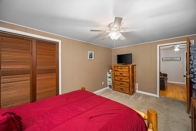 bedroom featuring light carpet, a closet, and ceiling fan