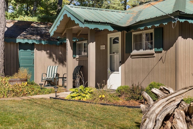 entrance to property featuring a lawn