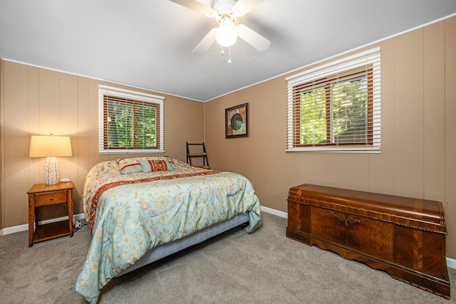 carpeted bedroom with multiple windows and ceiling fan