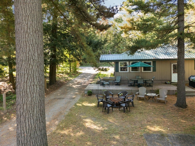 view of yard featuring an outdoor fire pit and a patio area