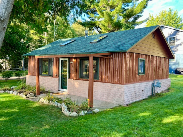 back of house with a lawn