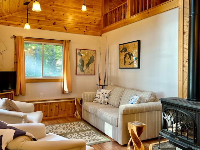 living room with wooden ceiling, hardwood / wood-style floors, a wood stove, and high vaulted ceiling