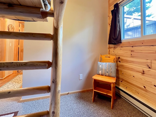 carpeted bedroom with a baseboard heating unit