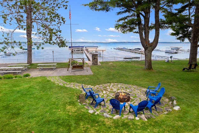 view of yard featuring a fire pit and a water view