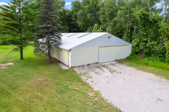 view of outbuilding with a garage and a yard