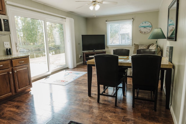 dining space featuring ceiling fan, crown molding, and dark hardwood / wood-style flooring