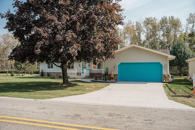 view of front of home featuring a front lawn, covered porch, and a garage