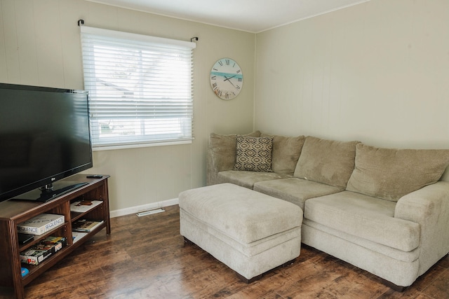 living room with ornamental molding and dark hardwood / wood-style floors