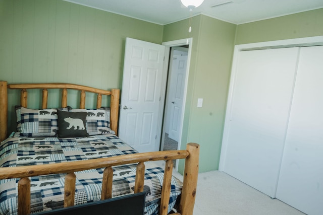 carpeted bedroom featuring a closet and crown molding