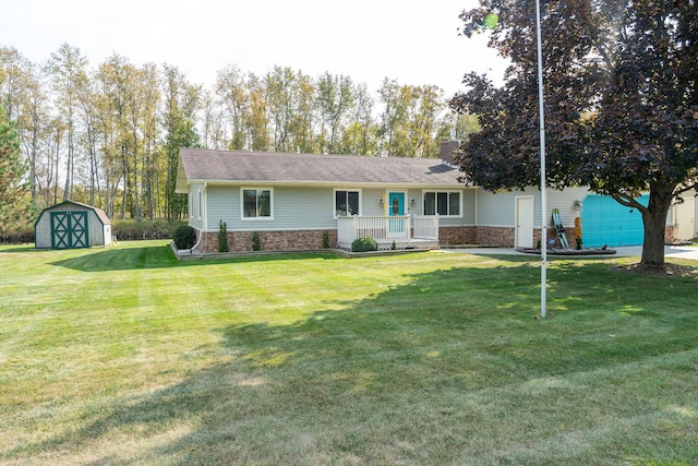 ranch-style home with a garage, a front lawn, and a shed