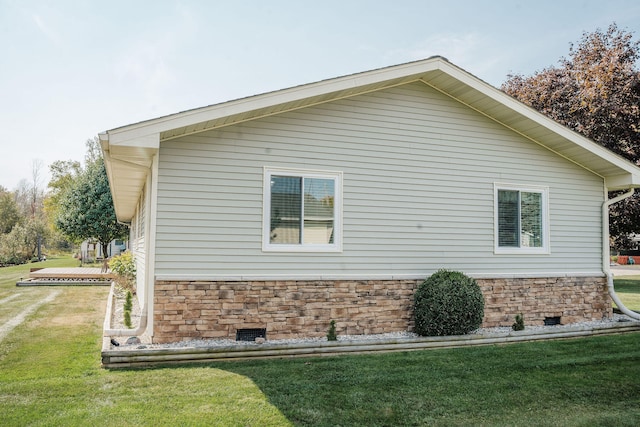 view of property exterior with a yard