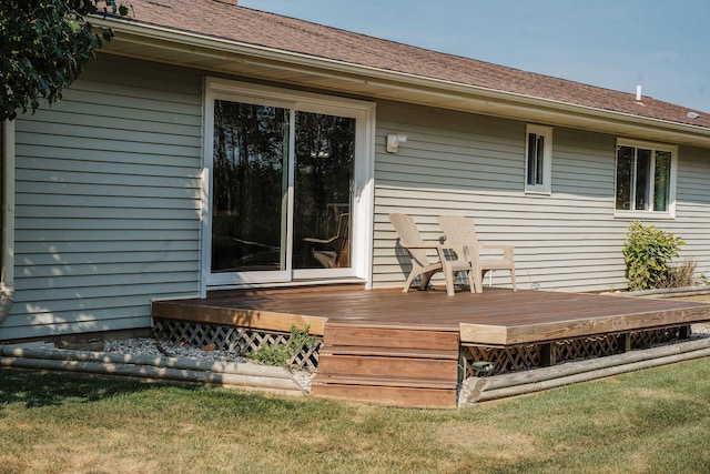 wooden terrace featuring a lawn