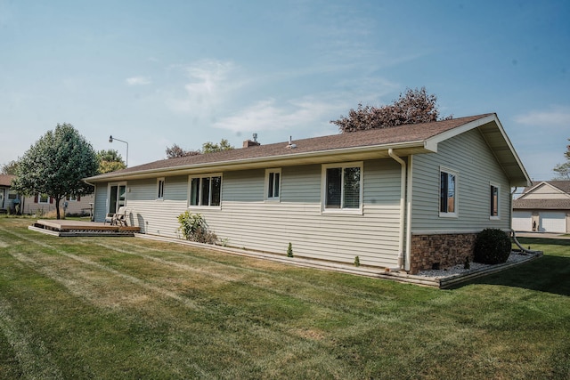 rear view of house with a yard