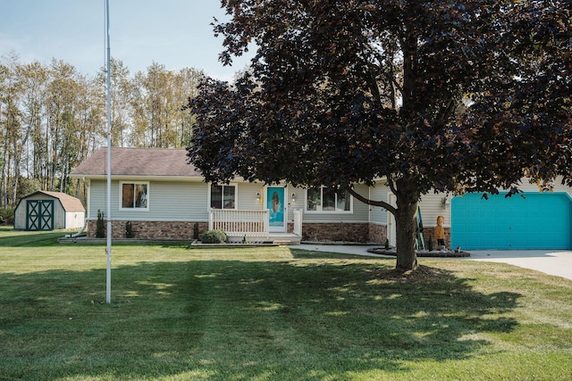 view of property hidden behind natural elements featuring a storage unit, covered porch, and a front yard