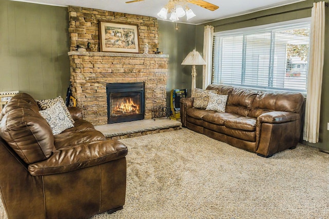 carpeted living room with a fireplace and ceiling fan