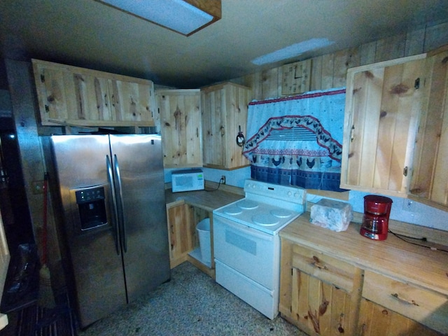 kitchen with stainless steel fridge, range, and light brown cabinets