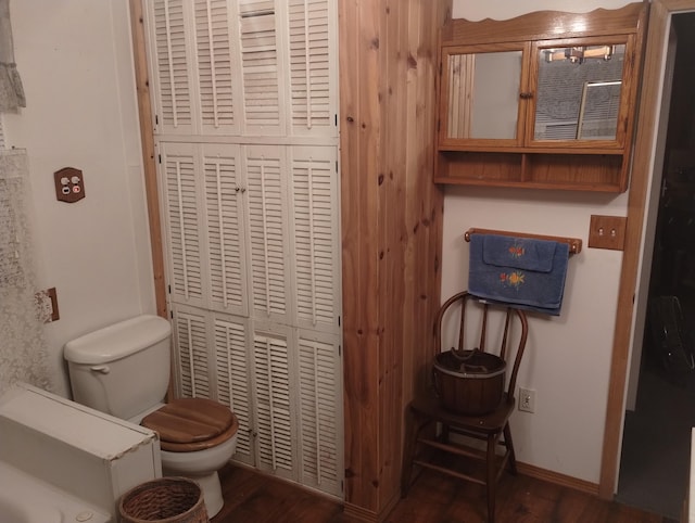 bathroom featuring hardwood / wood-style flooring and toilet