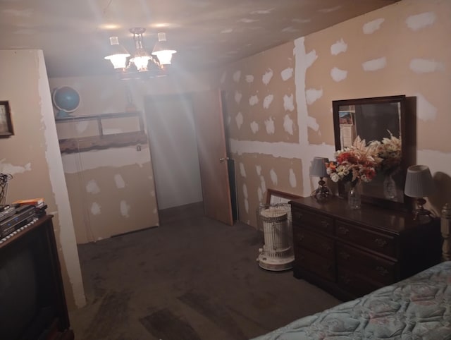 bedroom with dark carpet and an inviting chandelier