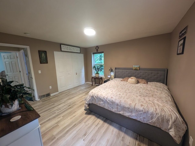 bedroom featuring light hardwood / wood-style floors and a closet