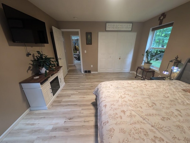 bedroom featuring light hardwood / wood-style floors and a closet