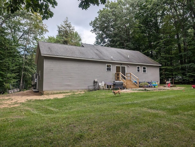 rear view of house with a yard