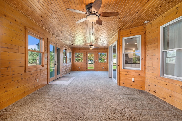 unfurnished sunroom featuring ceiling fan and wooden ceiling