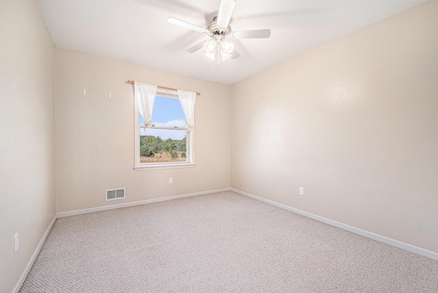 empty room featuring ceiling fan, carpet flooring, visible vents, and baseboards