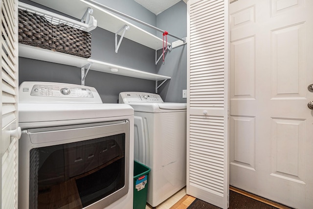 clothes washing area with laundry area and washer and dryer