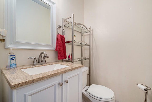 half bathroom with vanity and toilet