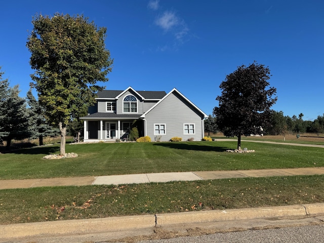 view of front facade with covered porch and a front lawn