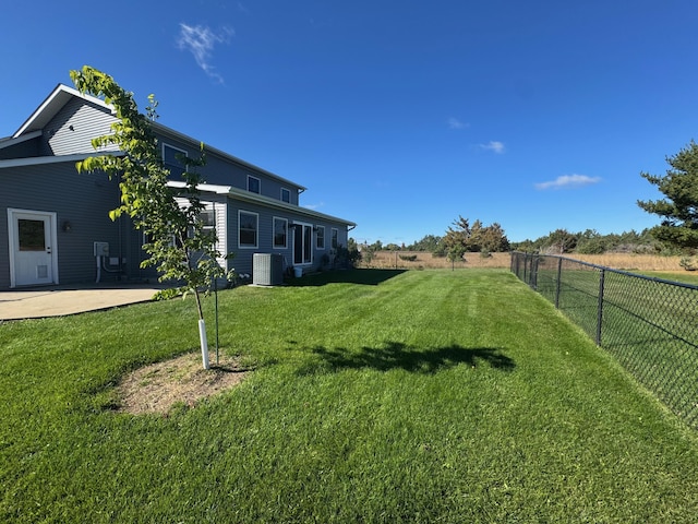 view of yard with a patio area, a fenced backyard, and central air condition unit