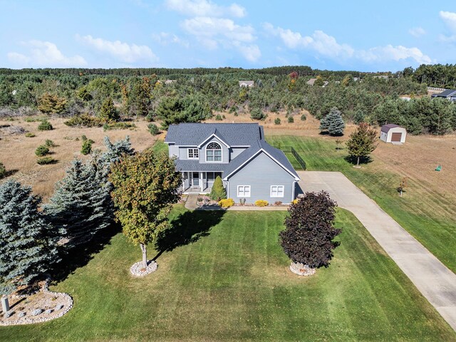 obstructed view of property with a front yard