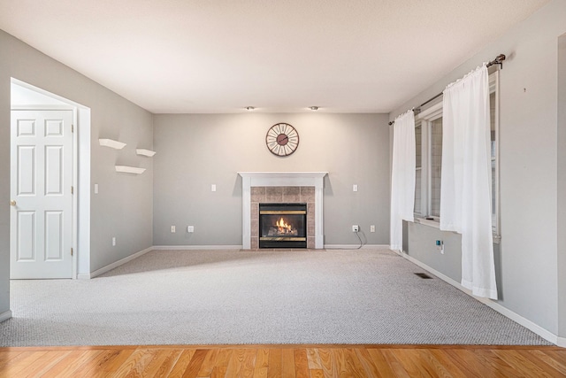 unfurnished living room featuring a fireplace and wood-type flooring