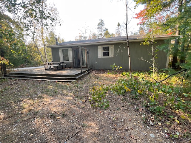 back of property featuring a wooden deck