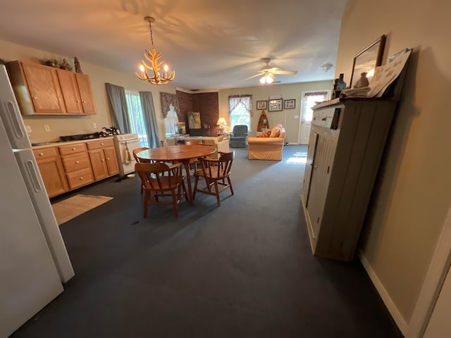 dining area with dark carpet and ceiling fan with notable chandelier