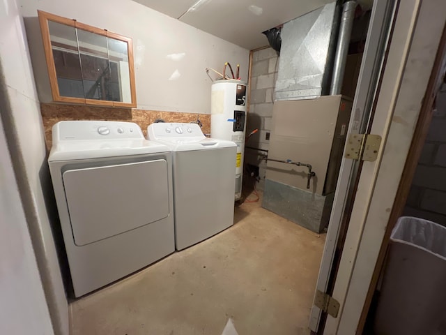 clothes washing area with separate washer and dryer and water heater