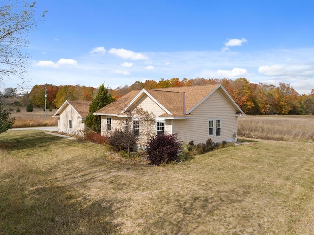 back of property featuring a yard