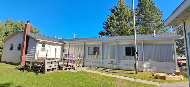 back of house with a lawn