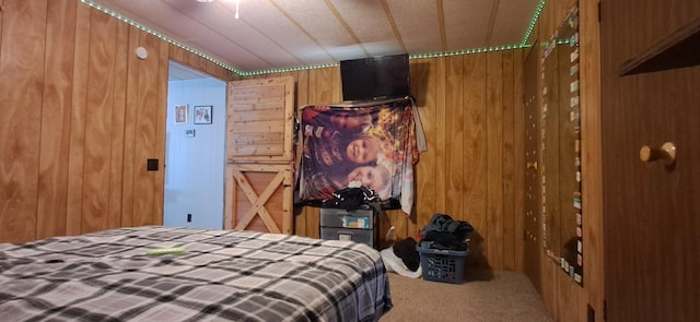 bedroom featuring wood walls and carpet flooring