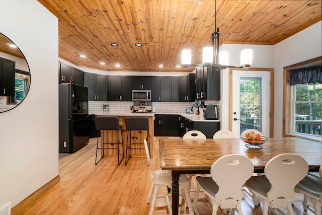 dining area with sink, wooden ceiling, and light hardwood / wood-style floors