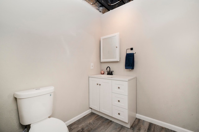 bathroom featuring vanity, toilet, and wood-type flooring