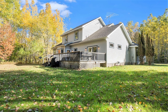 back of property featuring a yard and a wooden deck