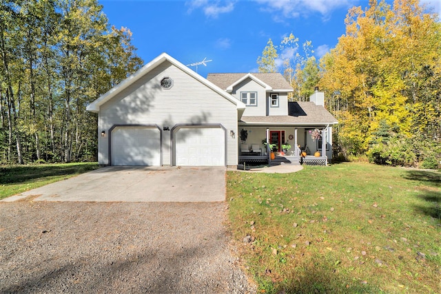 front of property with a porch, a front yard, and a garage