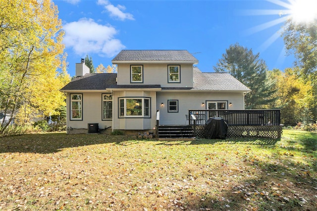 rear view of house featuring a wooden deck, central AC unit, and a lawn