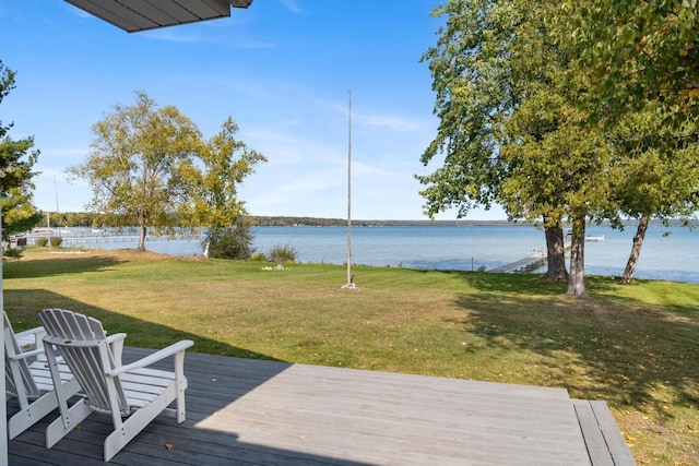 deck with a water view and a yard