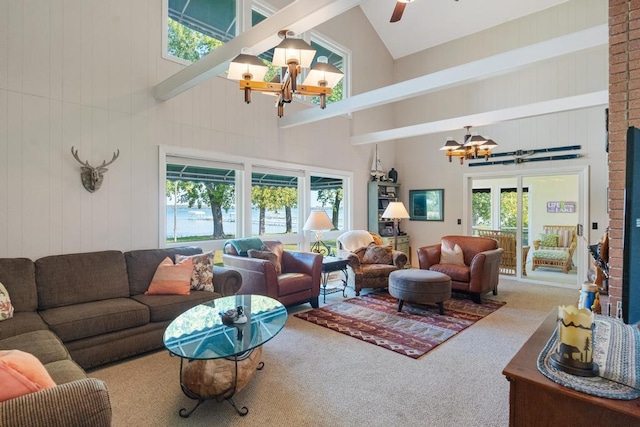 living room featuring beam ceiling, carpet, ceiling fan with notable chandelier, and high vaulted ceiling