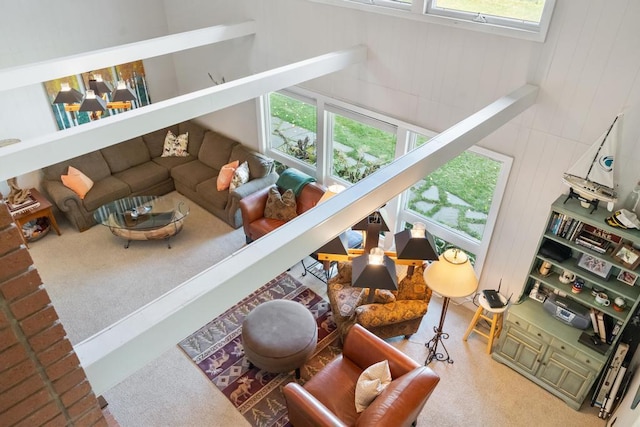 carpeted living room featuring a high ceiling