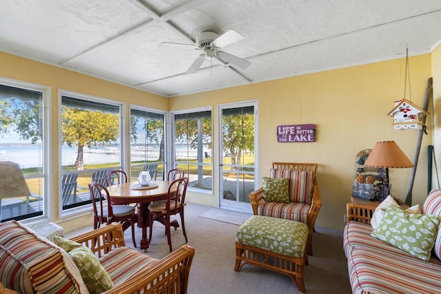 sunroom / solarium featuring ceiling fan